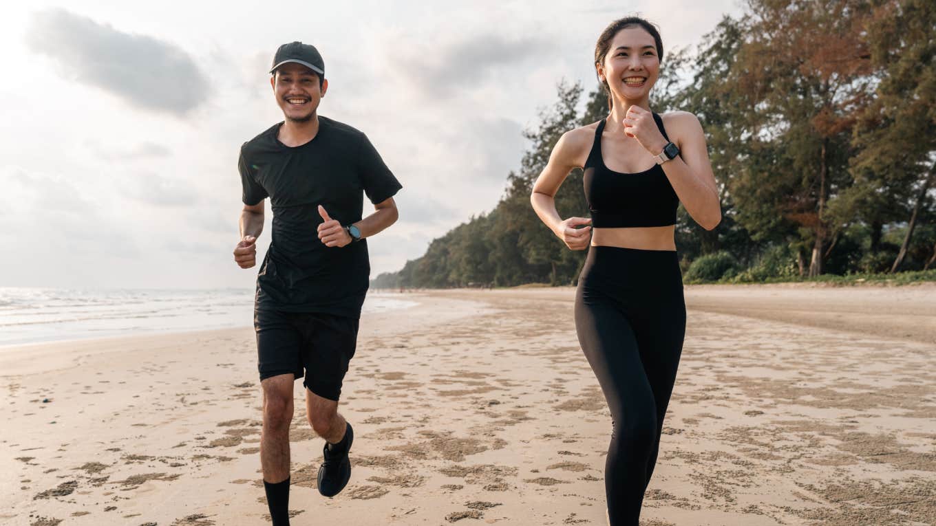 couple running together on the beach