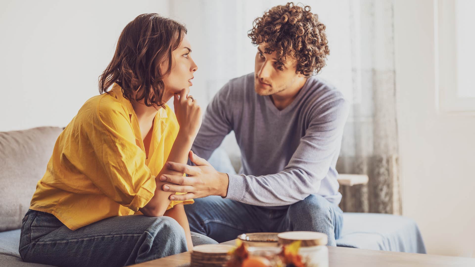 woman in yellow feels as if she's living with a stranger as man tries to comfort her