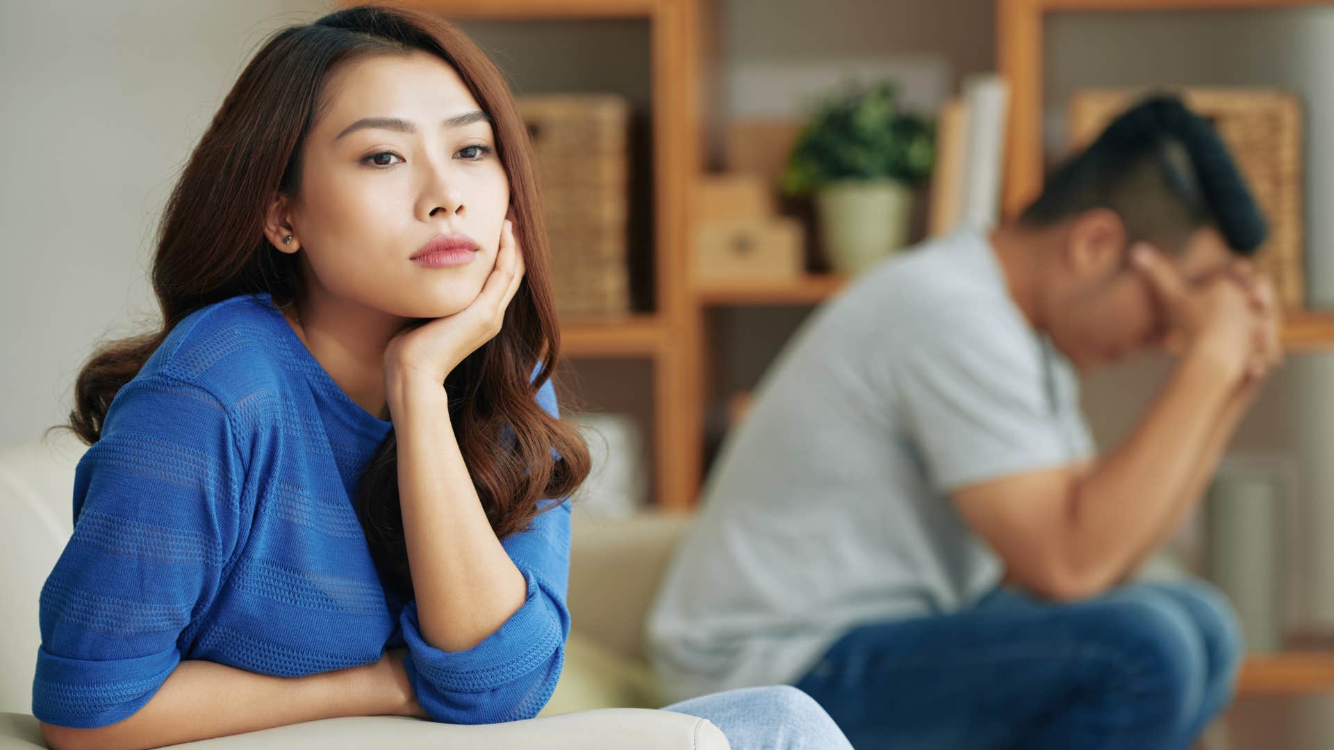 woman in dark blue shirt feels as if she's being put last and man in white looks down clearly upset