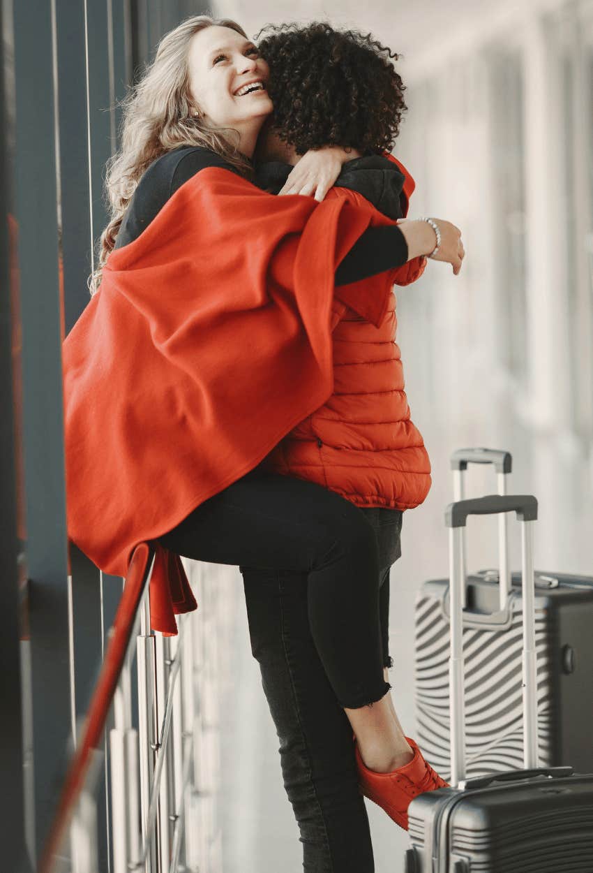 happy couple hugging at airport