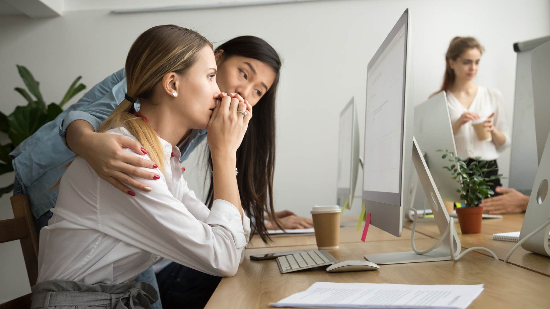 woman comforting her coworker being compassionate