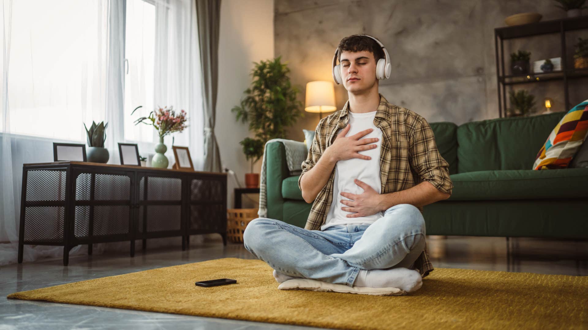 man practicing self-care by meditating