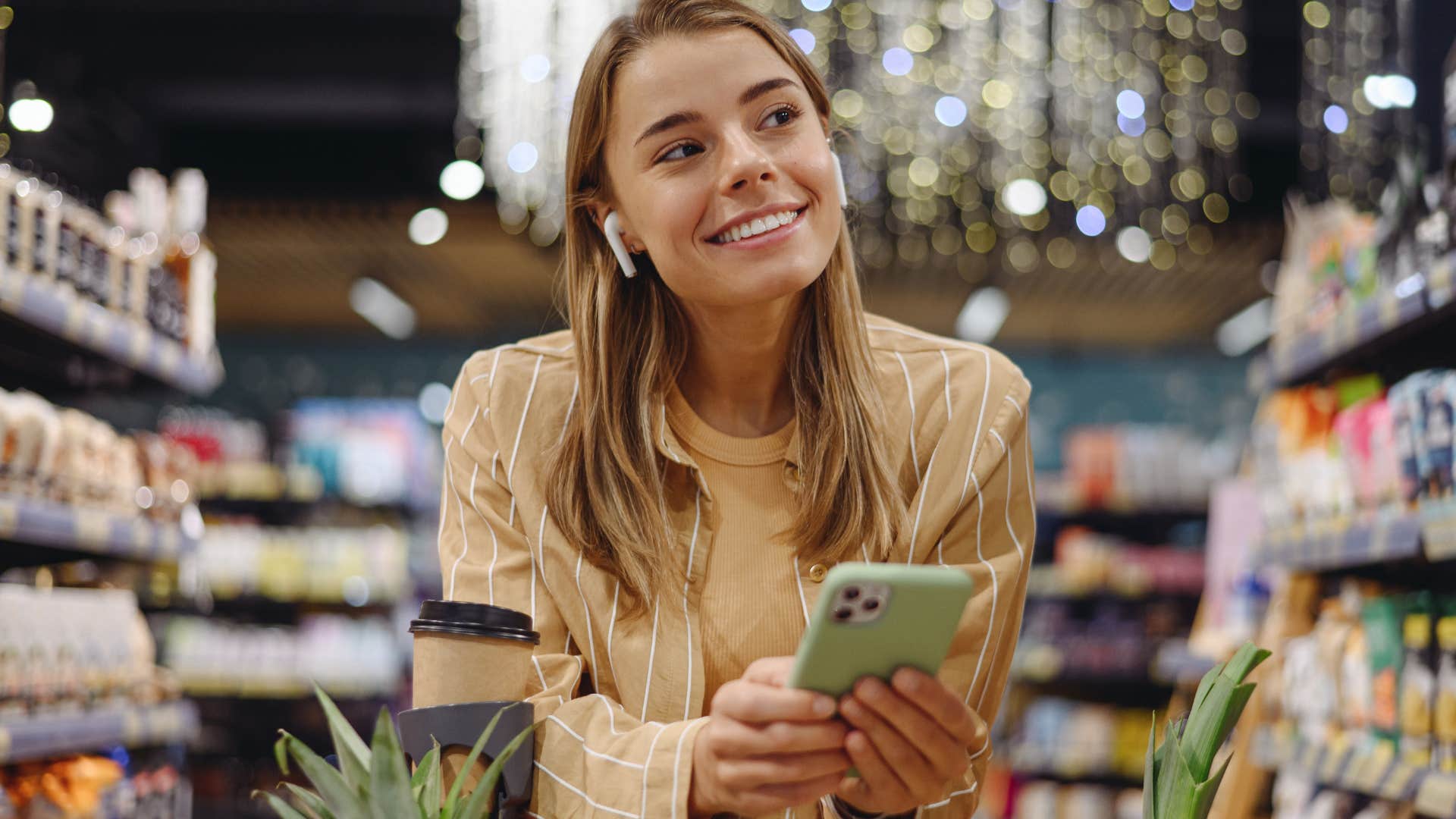 Woman using name-brand products in the grocery store.