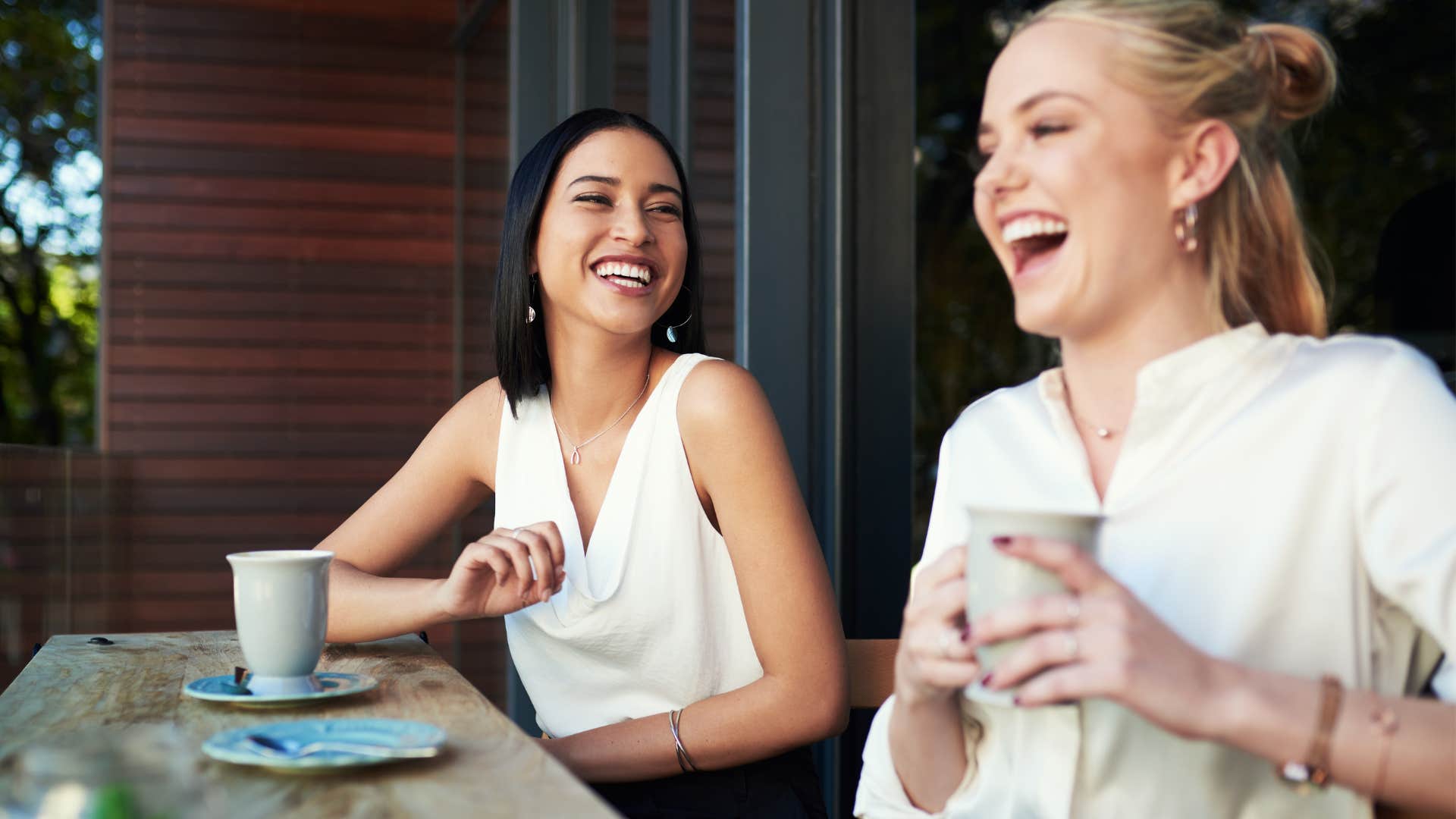 Woman who never says "no" drinking coffee with her friend.