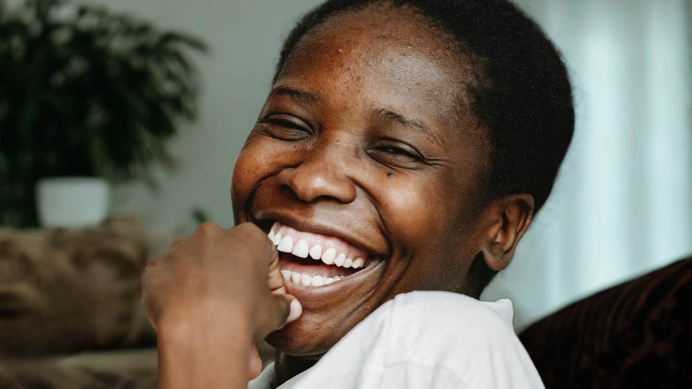11 Things Deeply Likable People Do On A Regular Basis, According To Psychology Deeply likable person smiling.