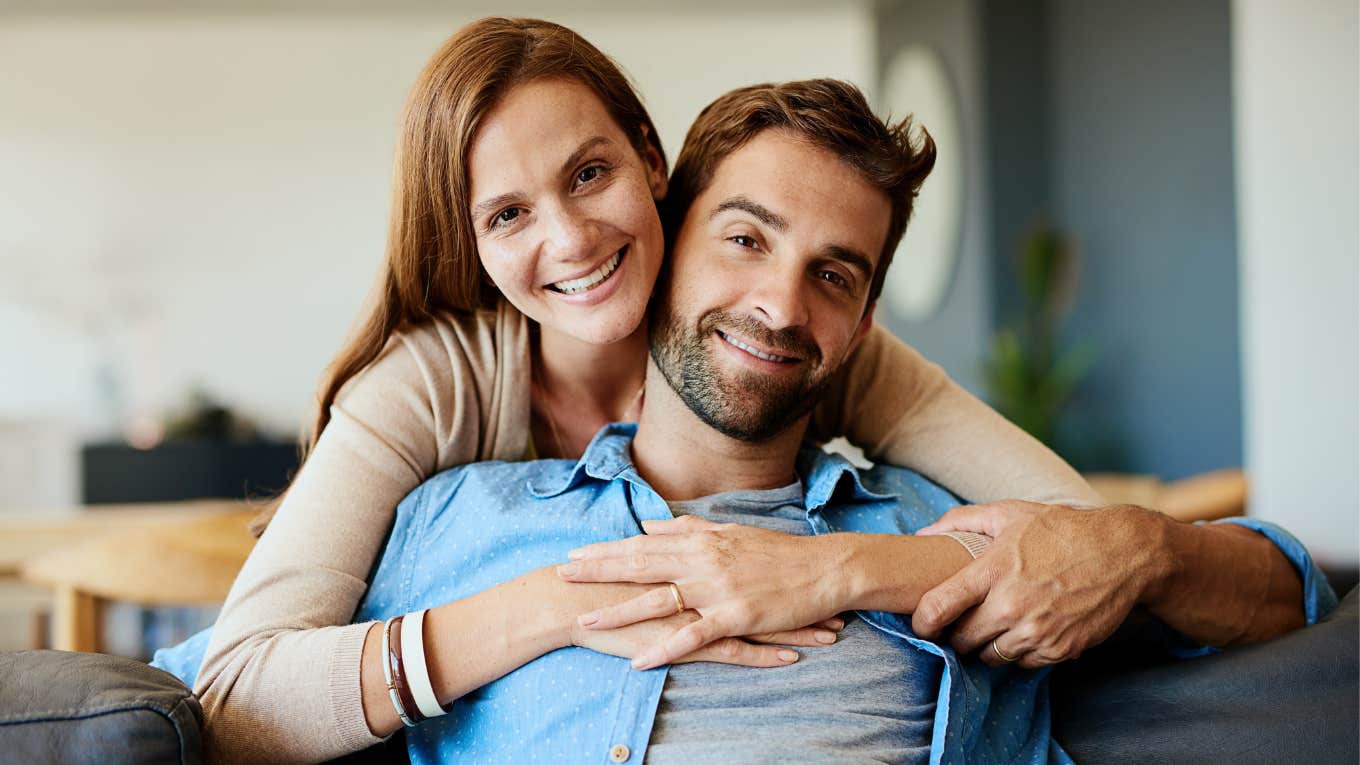 Distinct Traits Of Couples Who Actually Make It Through All The Hard Times happy couple hugging on the couch