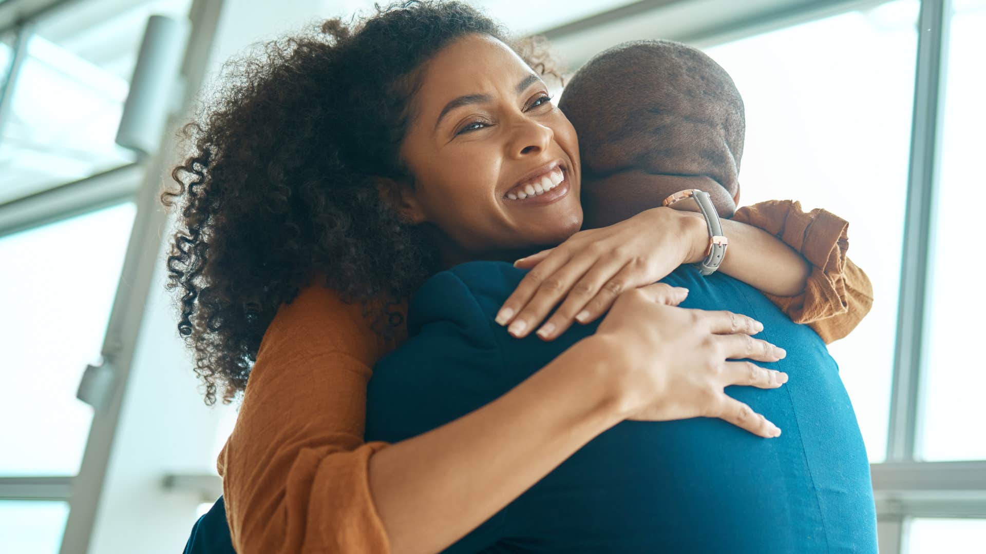 forgiving women smiling and hugging her partner