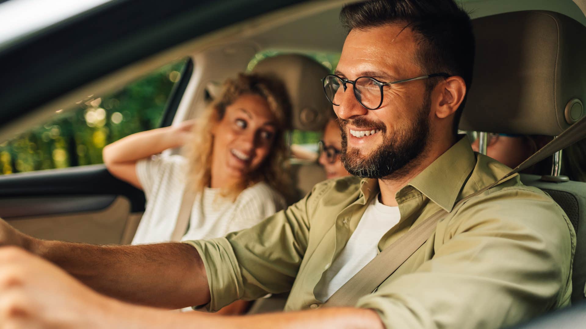 man who prioritizes the little things smiling in the car next to his partner