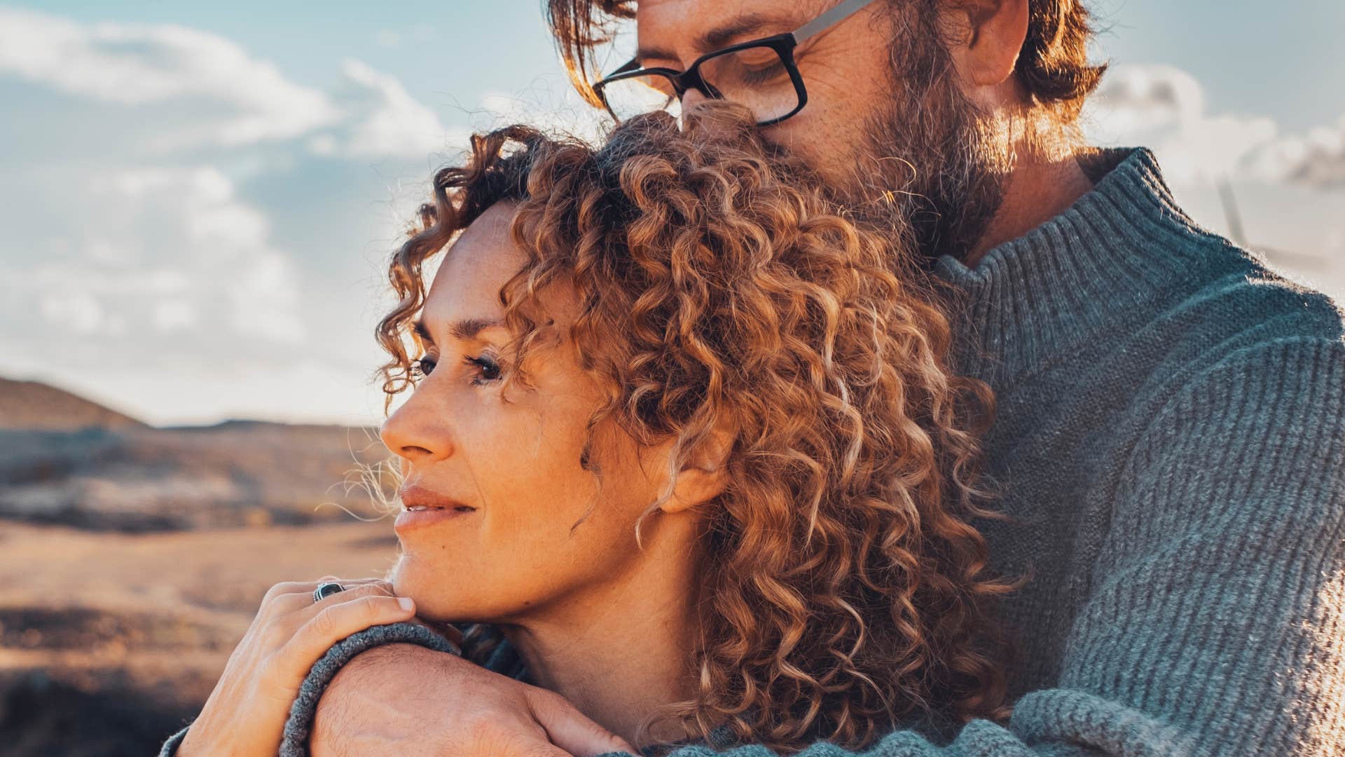 patient man hugging his partner from behind