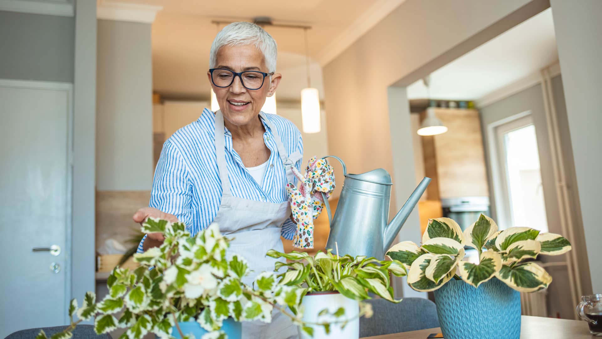woman cultivating house plants for positive energy