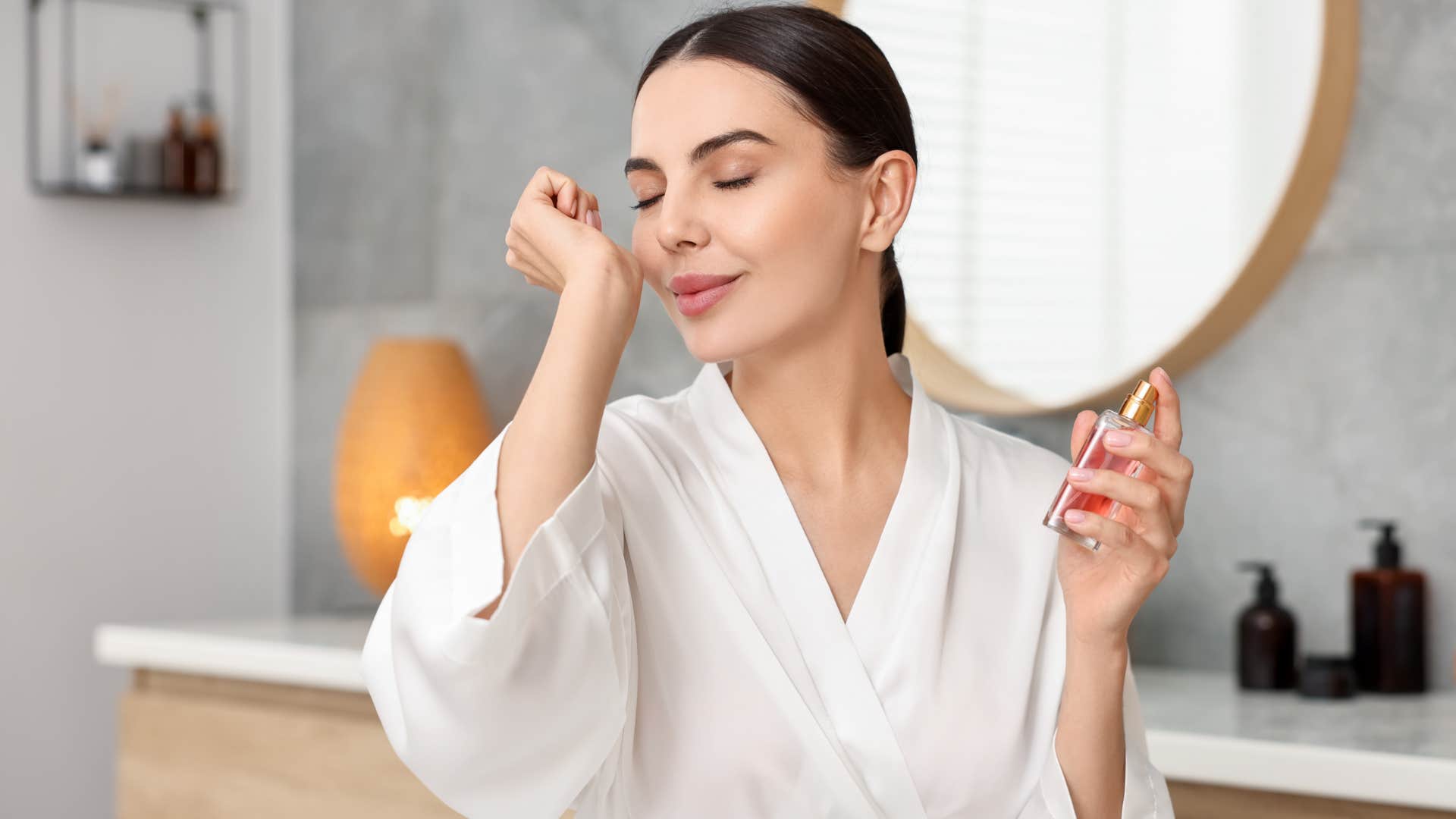 woman spraying essential oils on her after shower