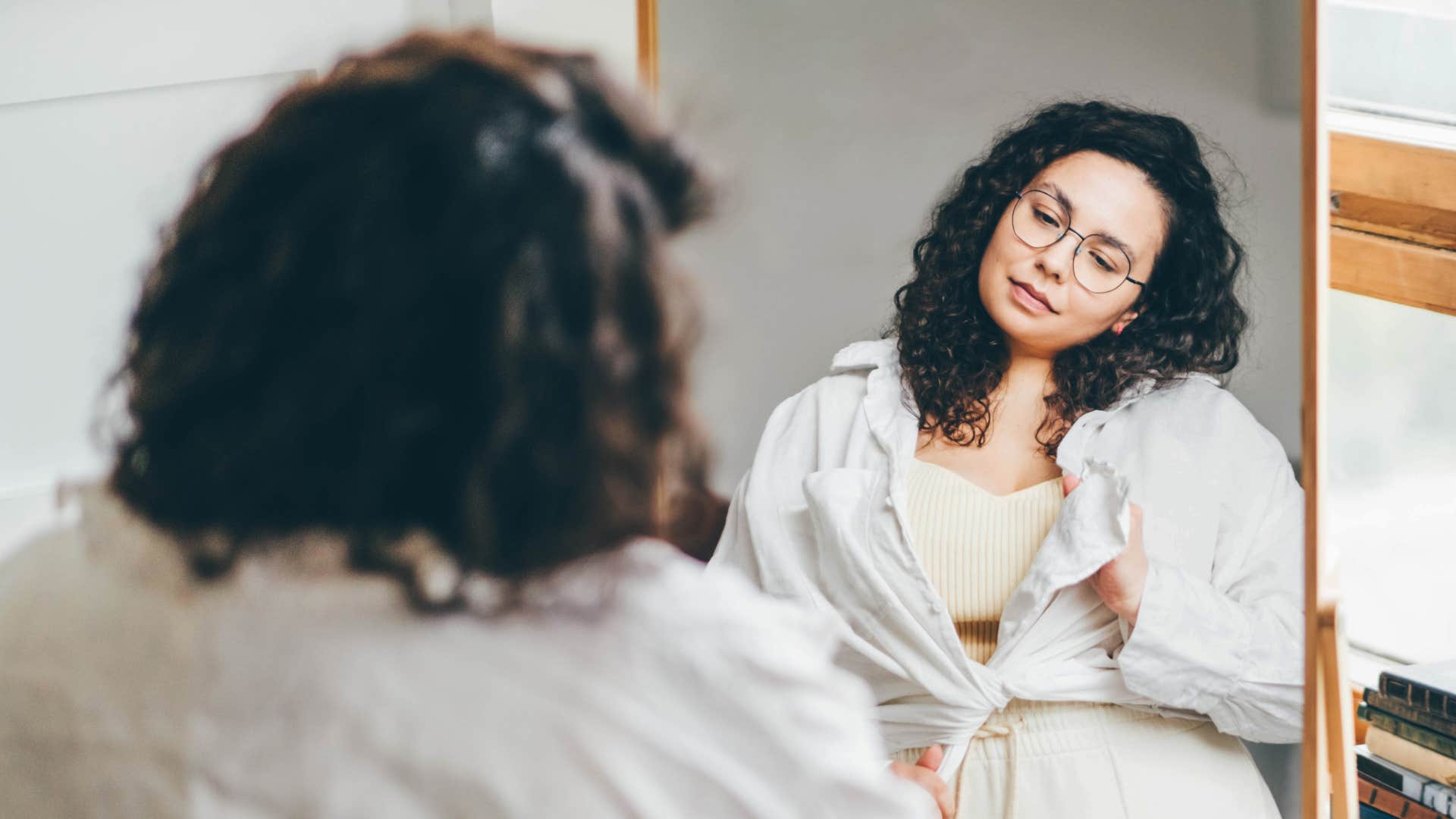 woman looking in mirror