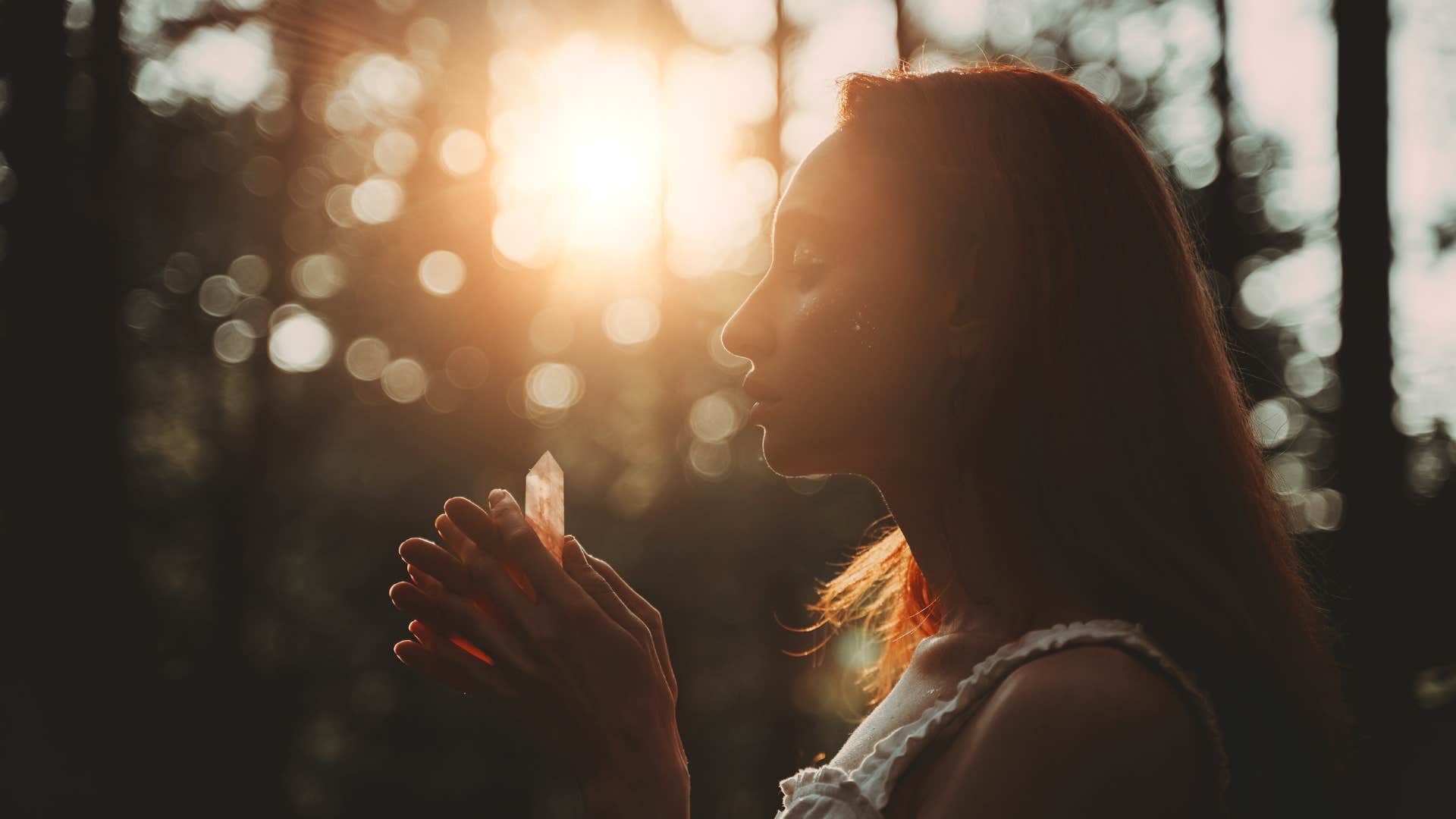woman holding a crystal outside