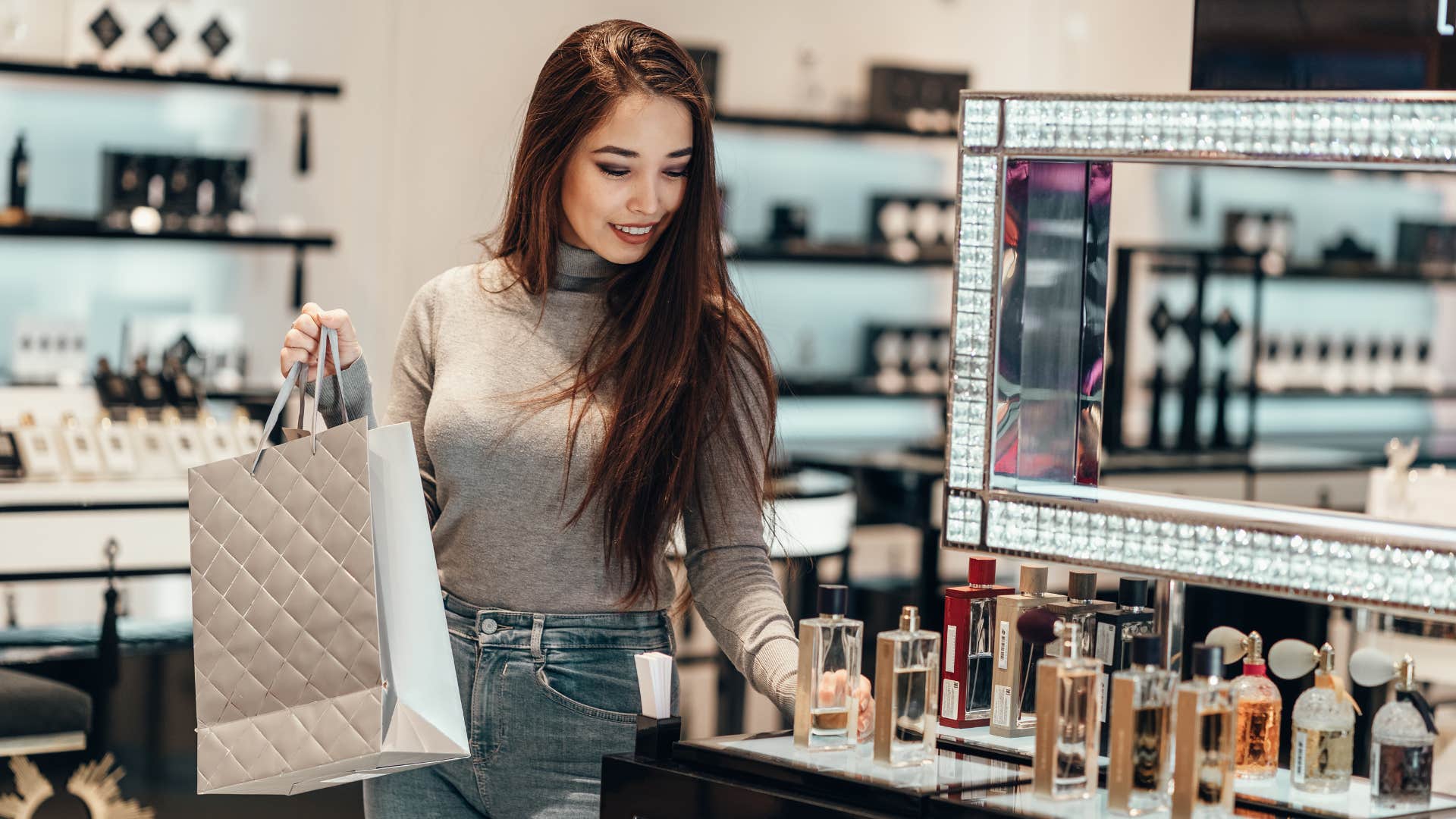 woman in brown sweater looking at products as she spends her entire paycheck on overpriced makeup and skincare