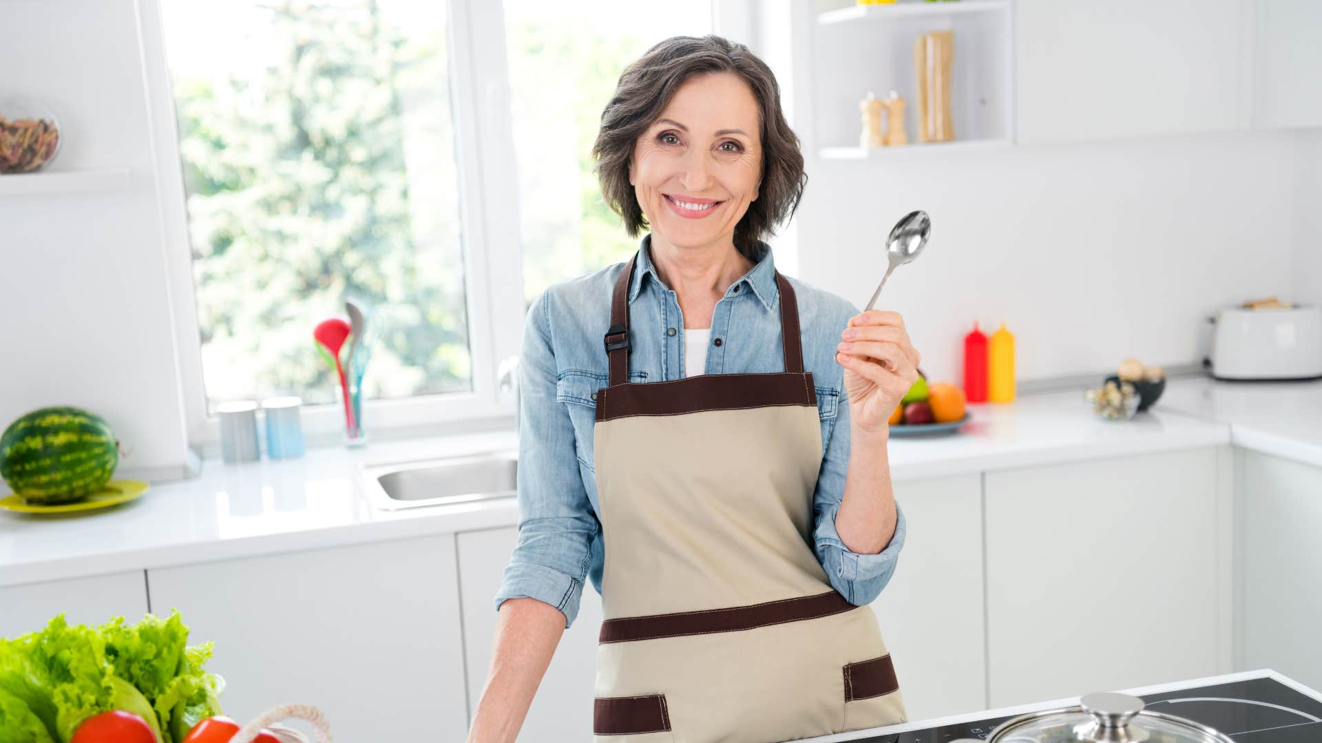 woman holding rusted spoon smiling