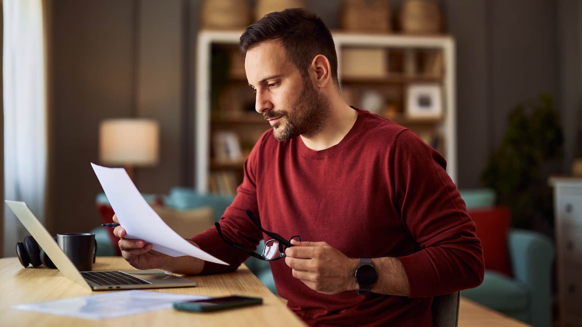 man reading old instruction manual