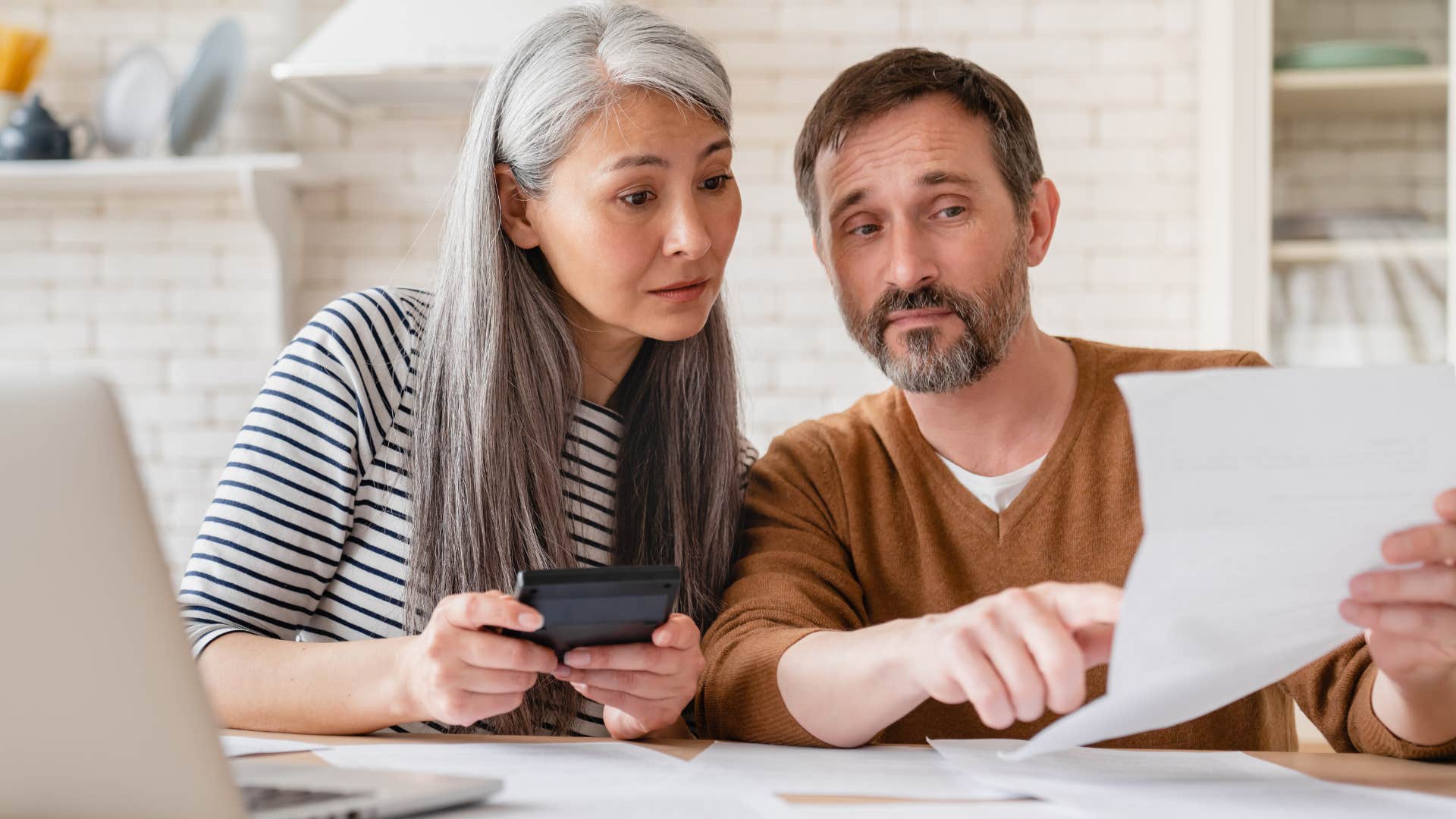 a couple look over their insurance premium costs