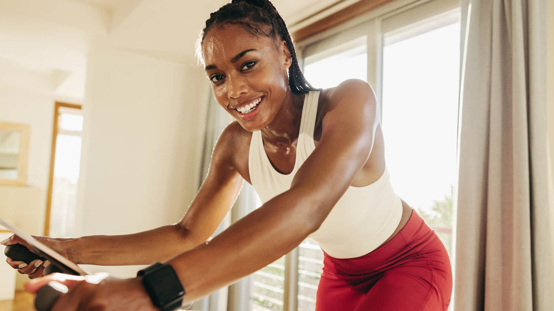 Woman with fitness clothes or memberships working out at home.