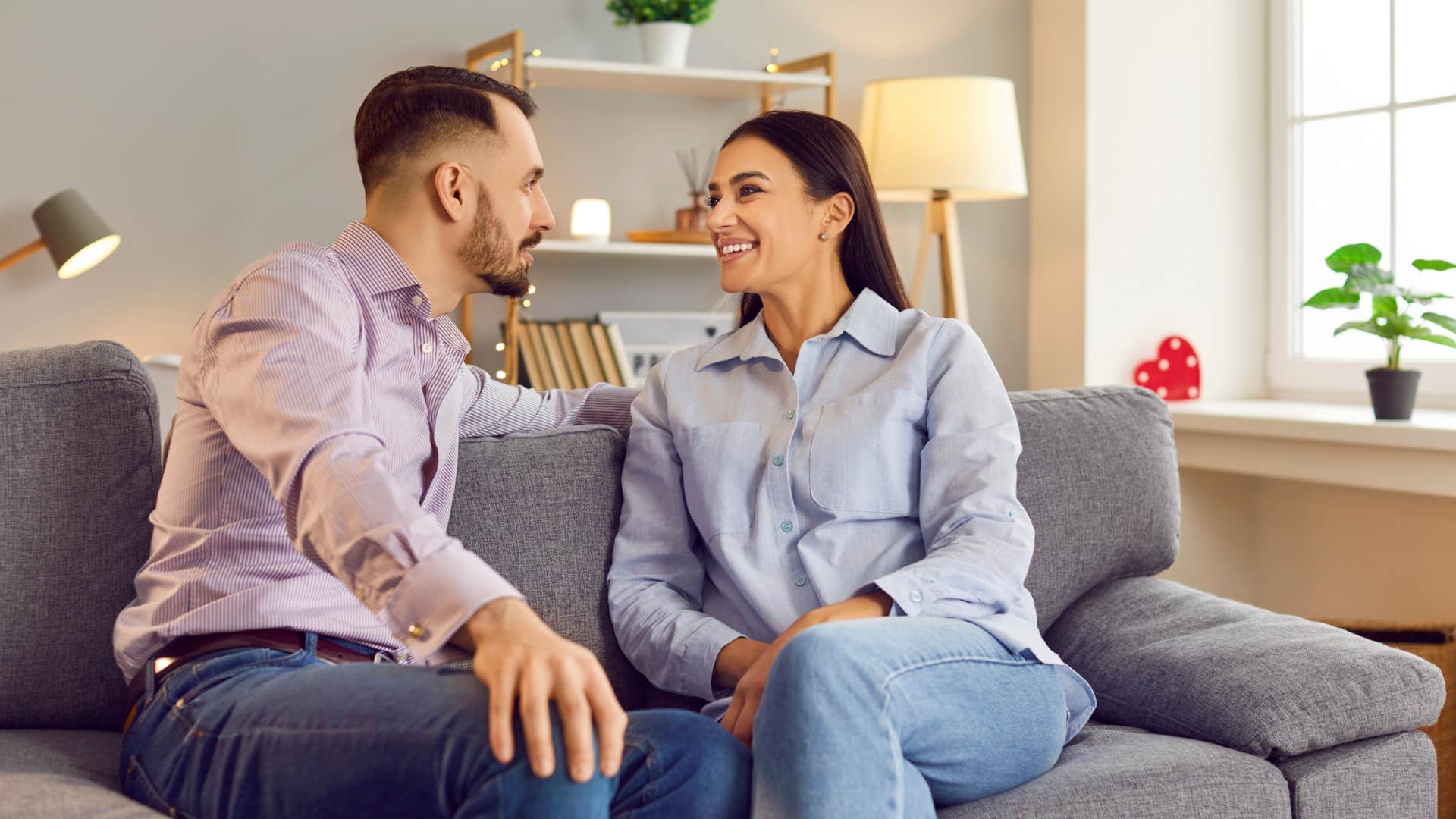 happy kindred spirit couple talking on the couch