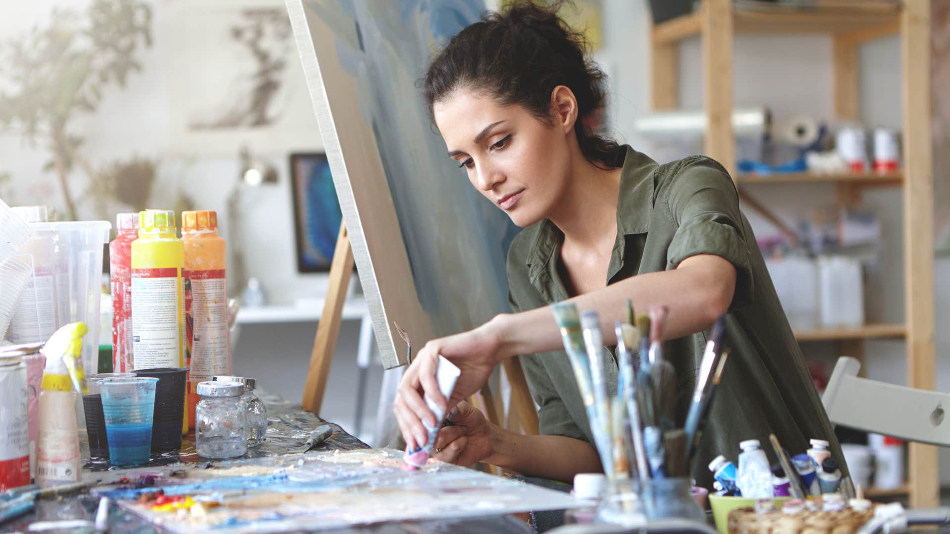 classy woman painting expressing herself with creative hobby