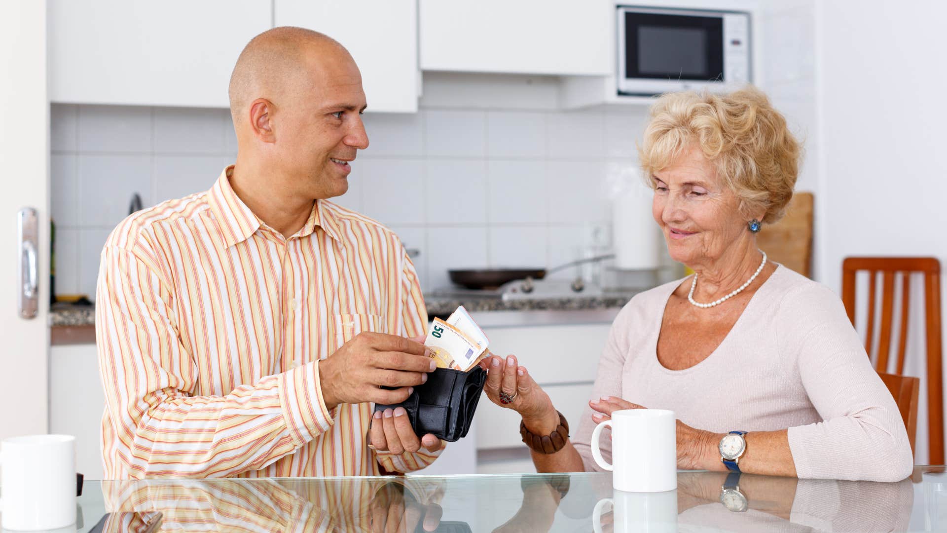 man making more money by giving mother money