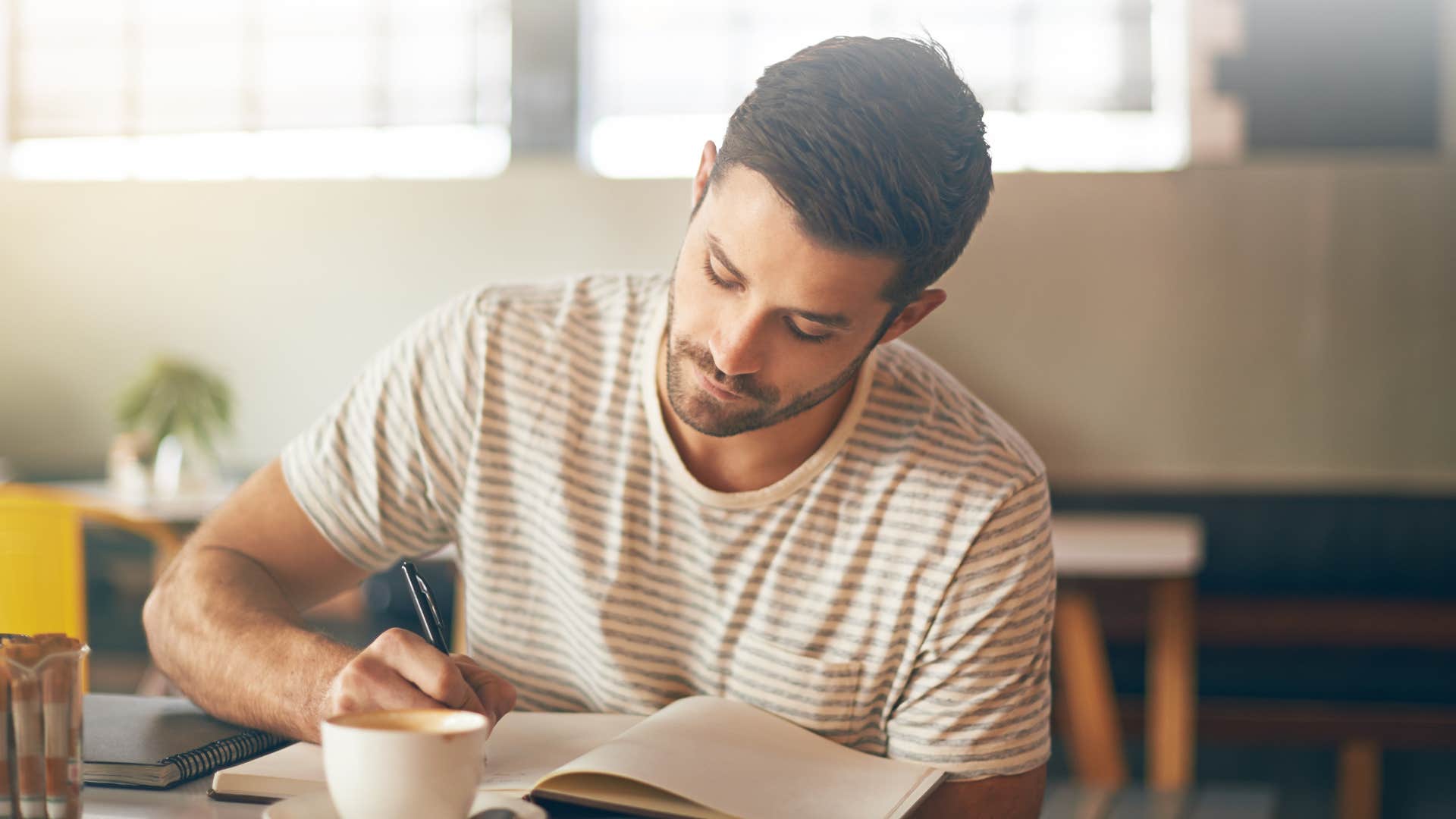 man journaling for self-awareness