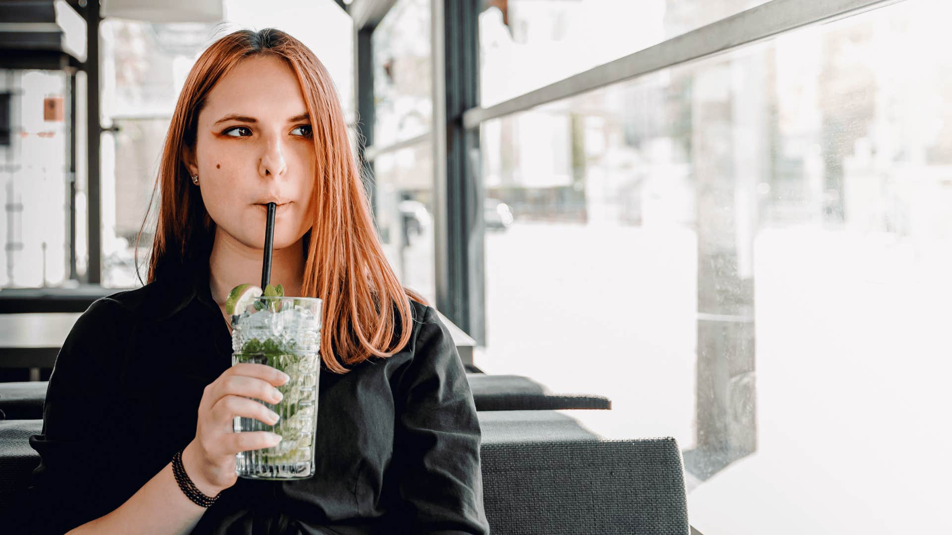 woman who doesn't live below her means splurging on expensive drink