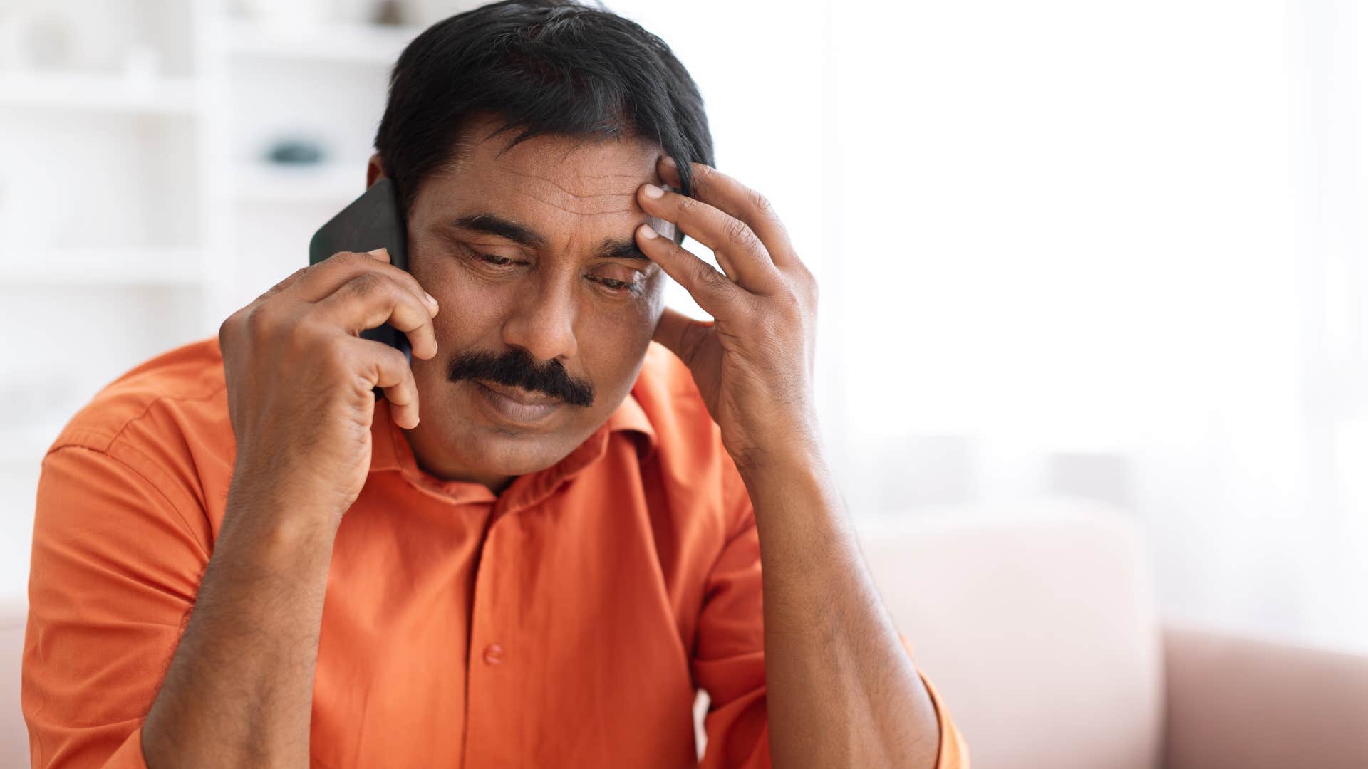 Man avoiding conversations about money on the phone.