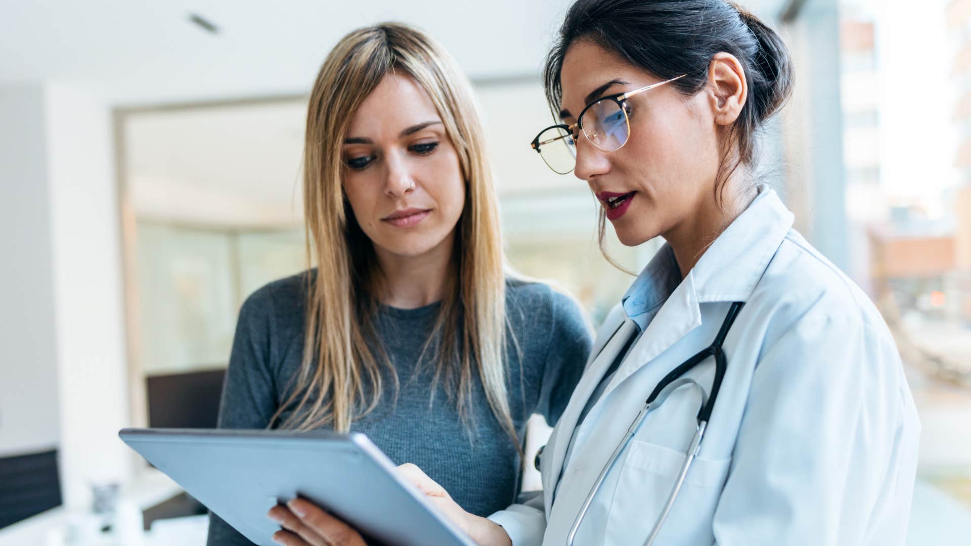 Woman who's not overlooking preventative healthcare talking to her doctor.