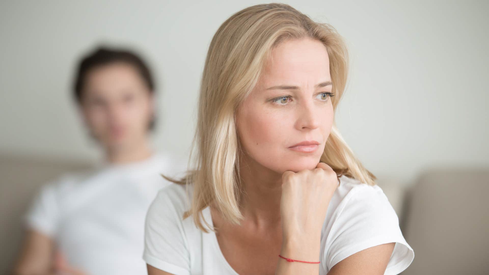 woman thinking about how partner cheated on his ex with her