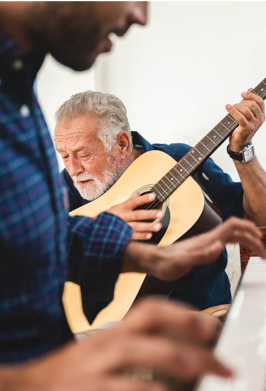 elderly man playing guitar