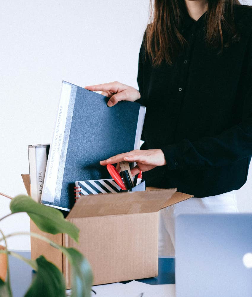 worker packing up her office after being laid off
