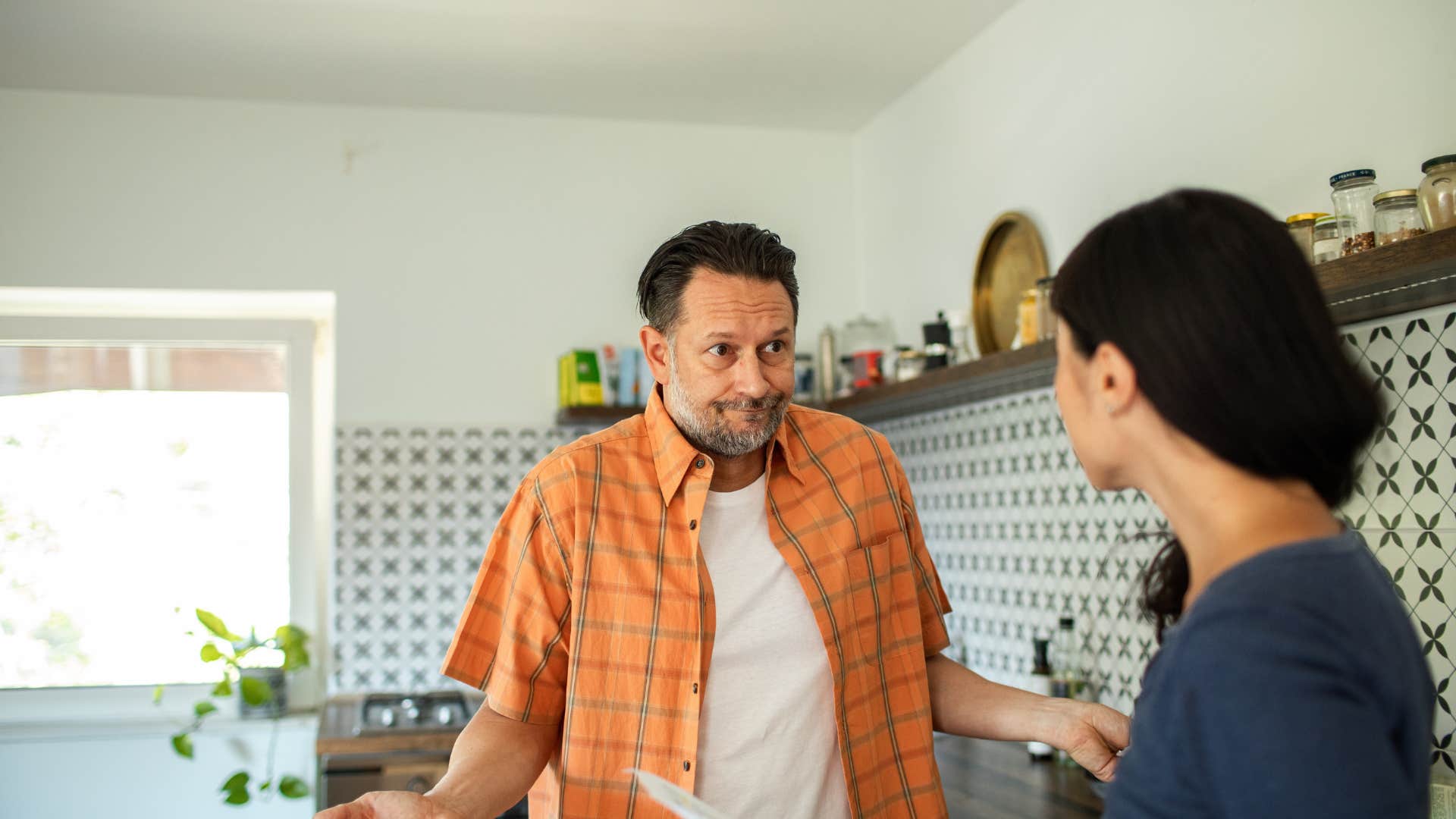 couple having serious conversation in kitchen