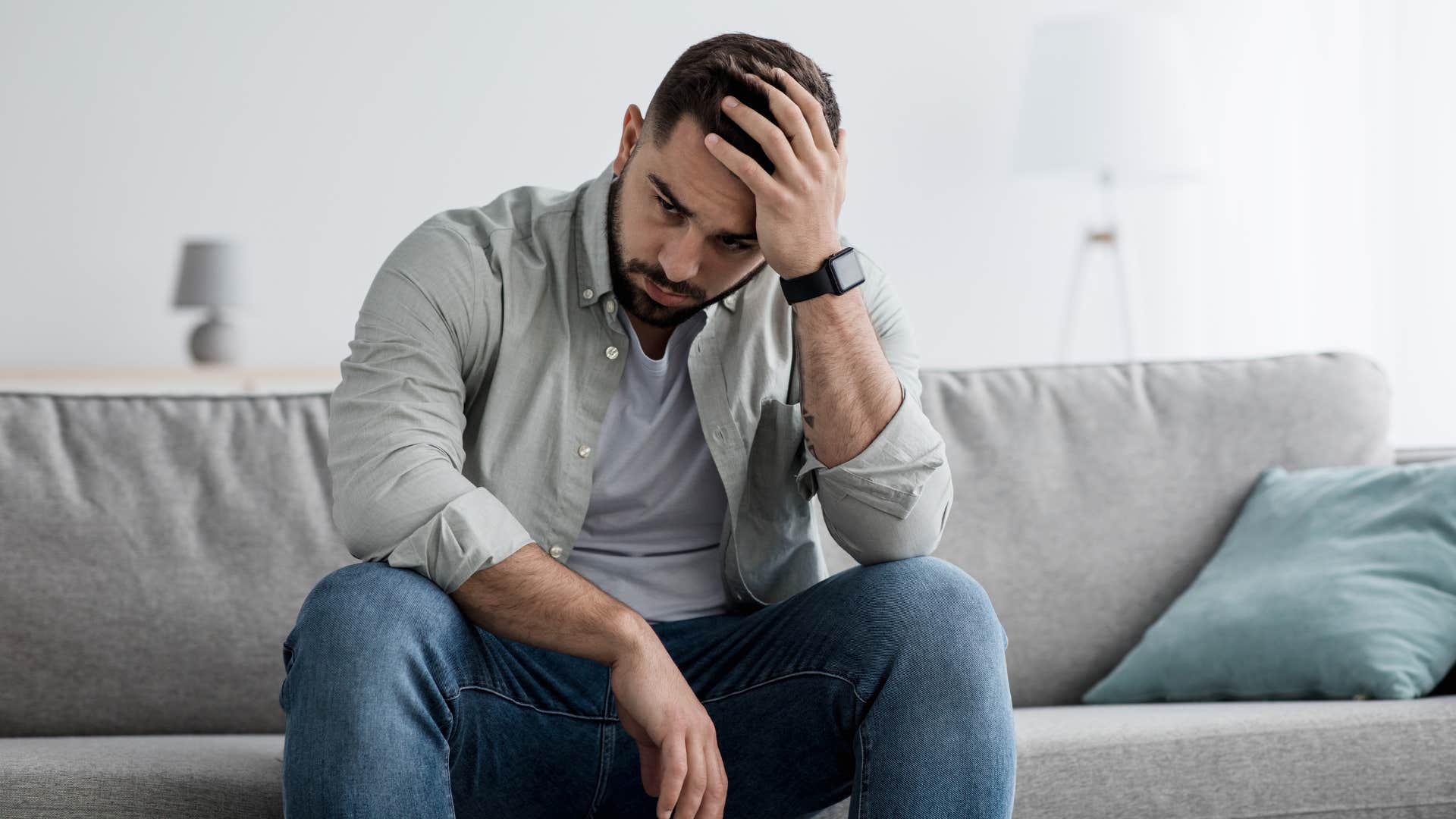 stressed man sitting on couch