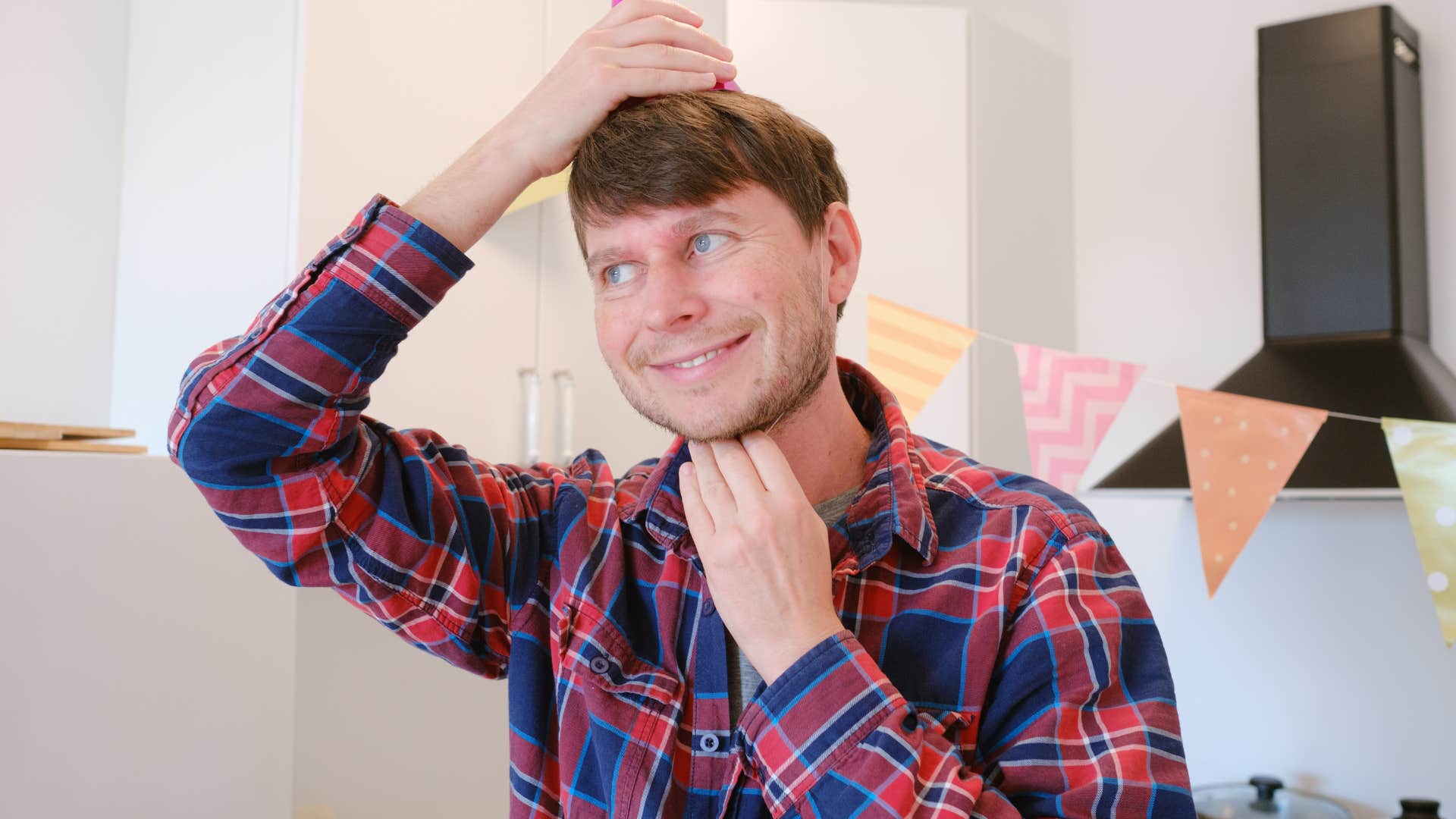 man decorating his house with dollar store decorations