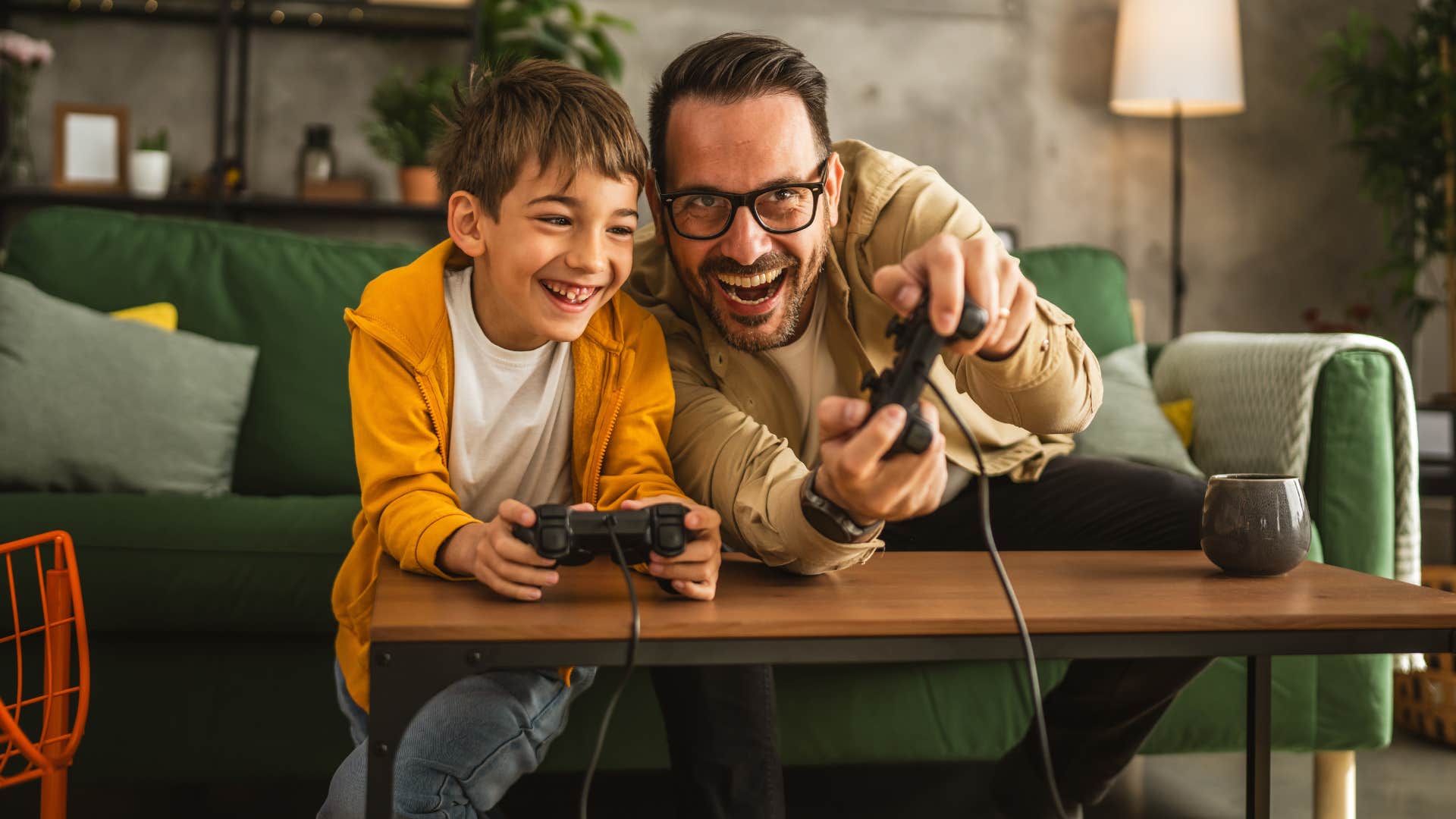 father and son using a shared game console