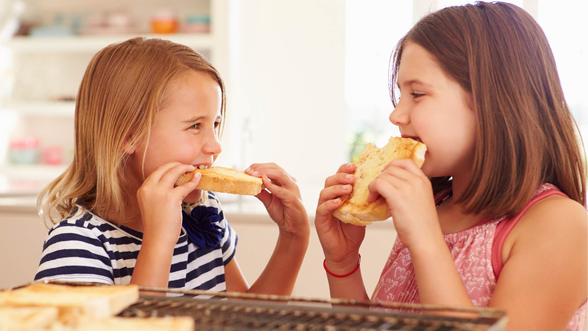 two girls eating simple grilled cheese at home