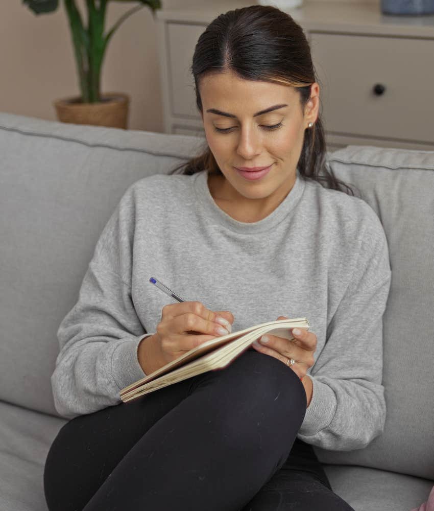 Woman journaling to access inner spiritual guide message about soulmate 