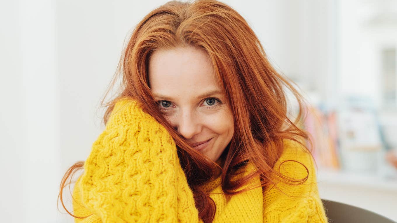 Internal Changes People Make Right Before They Become Happier Than Ever smiling woman looking happy in a sweater
