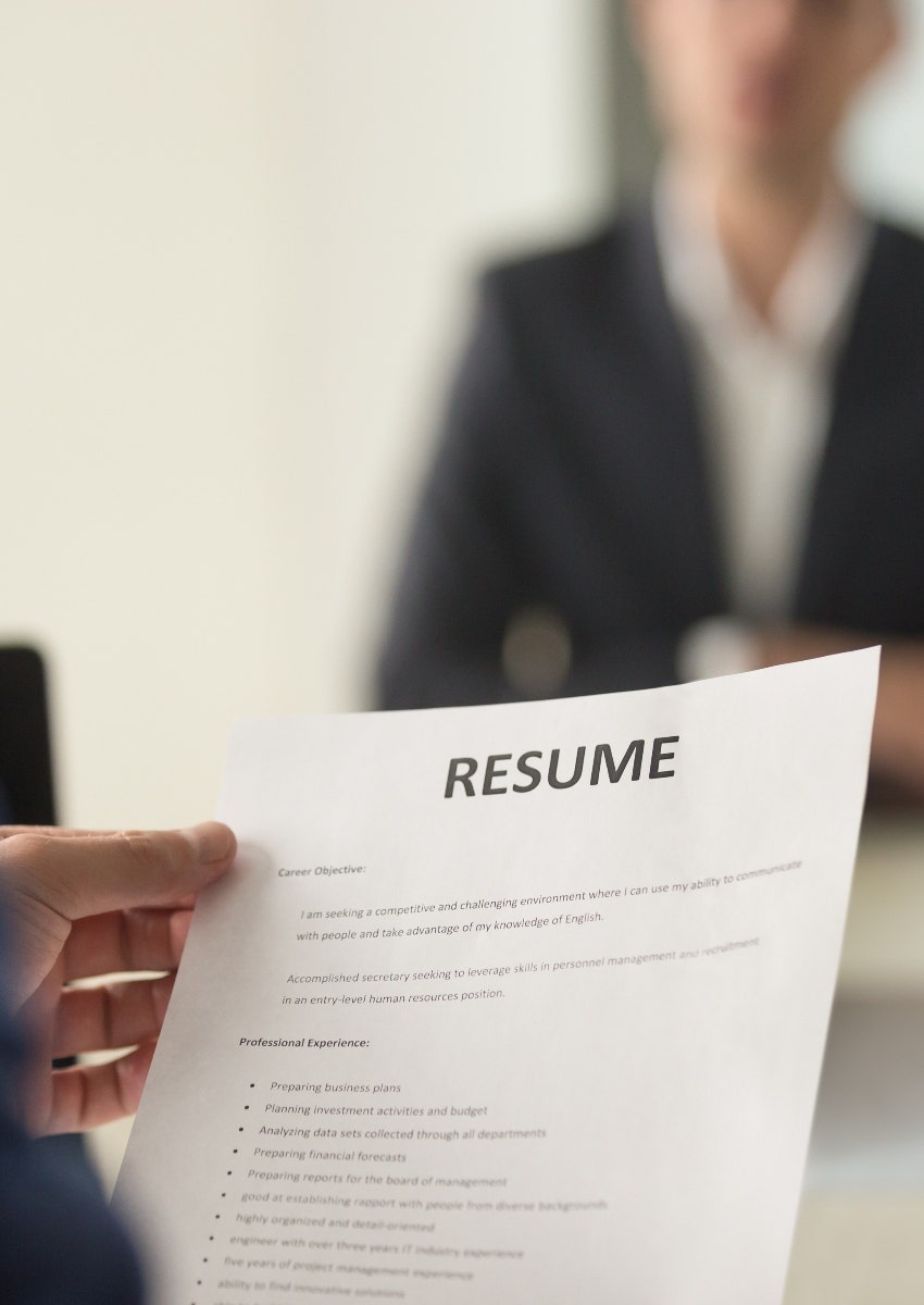 hiring manager holding resume at job interview
