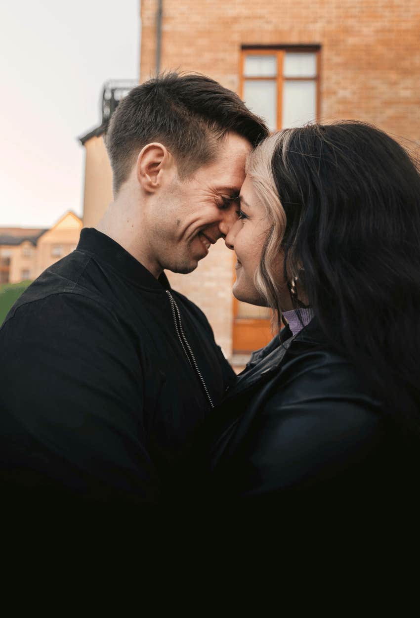 smiling couple leaning in