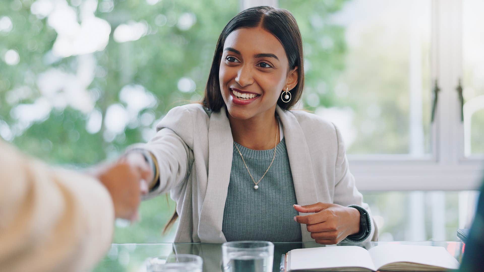 woman networking and shaking hands with a peer