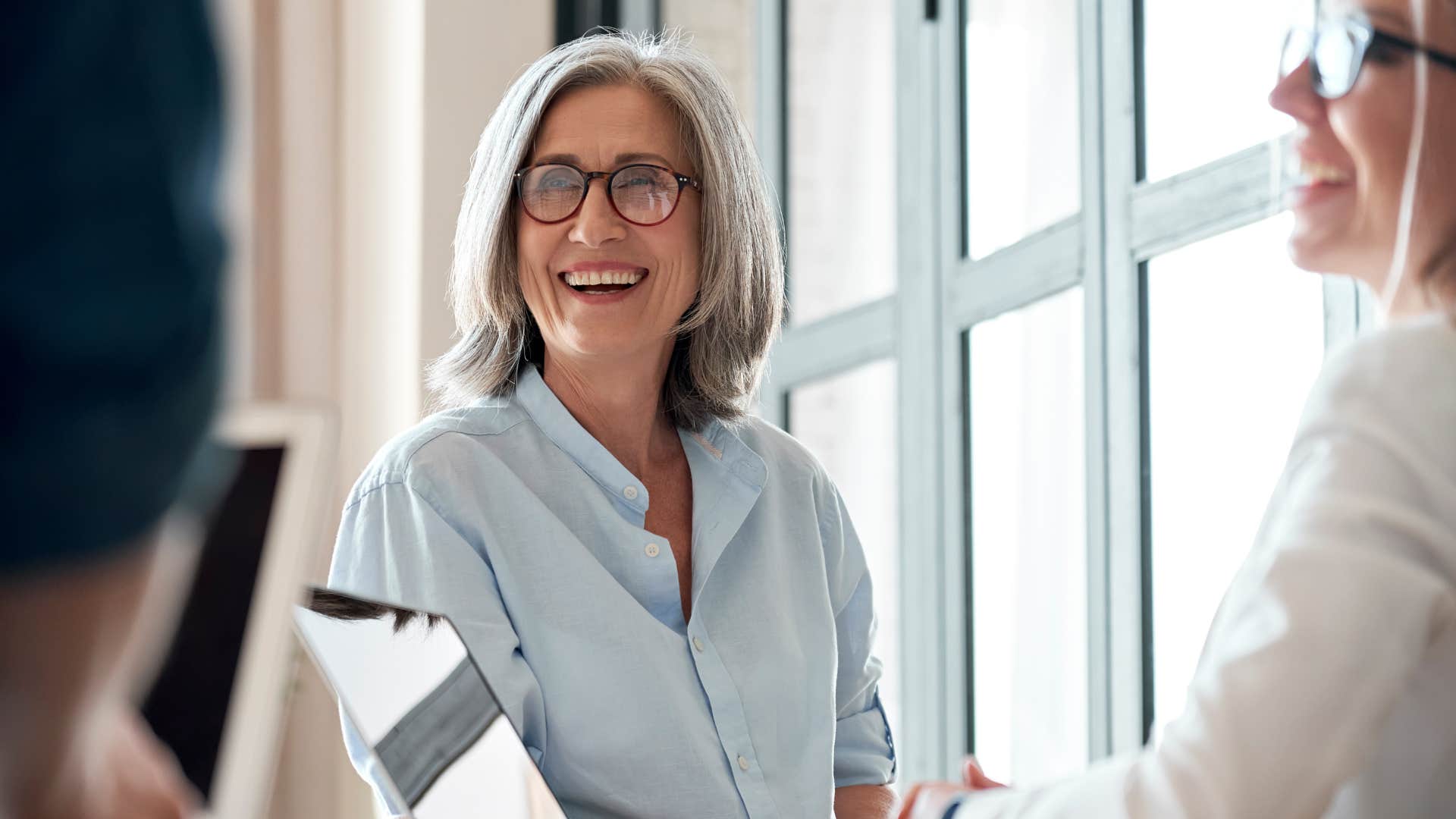 woman in blue shirt and glasses being the smartest in a room
