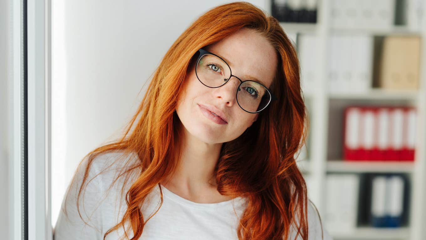 brilliant woman standing in her office