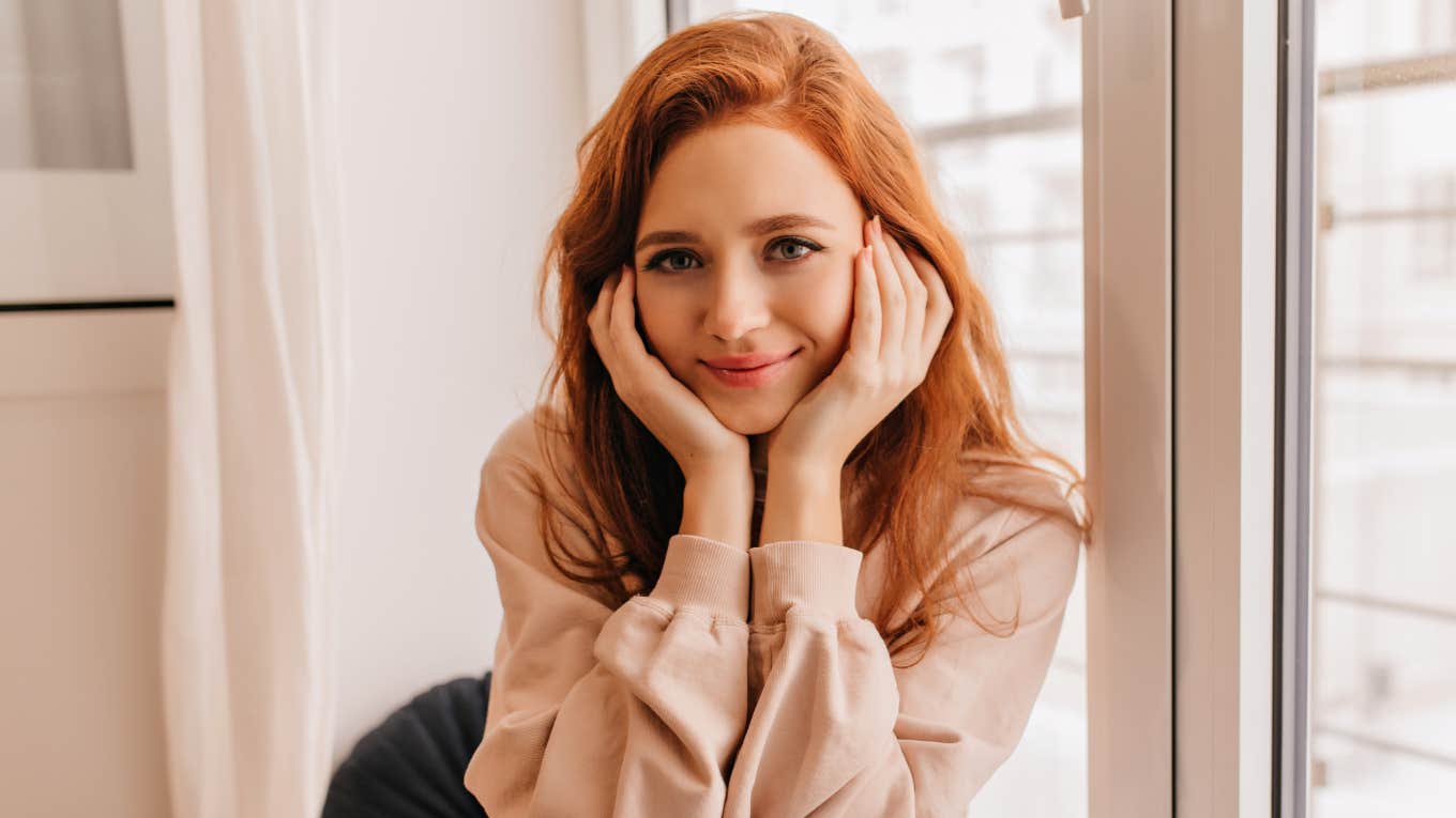 classy woman sitting in her home by the window