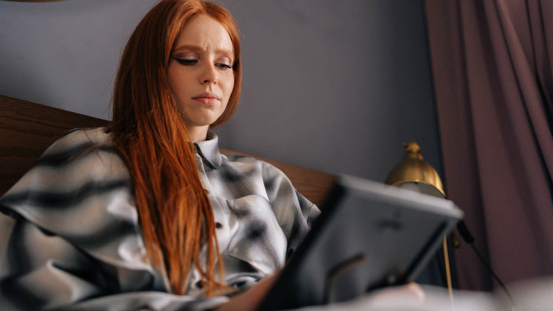 sad woman holding sentimental items at home