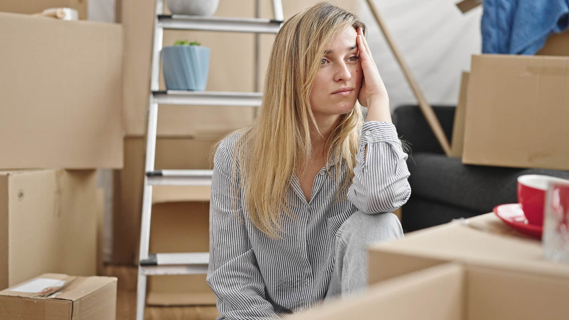 unhappy woman sitting with unopened packages