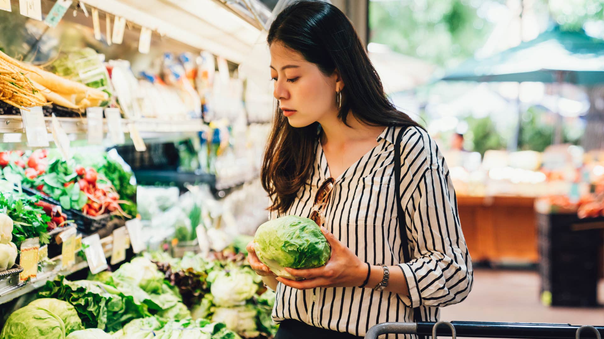 Woman buying seasonal produce in the grocery store.