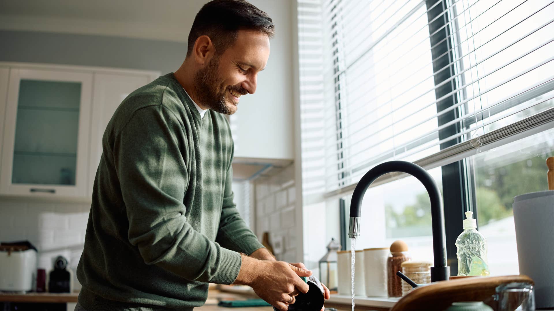 frugal man doing chores washing dishes