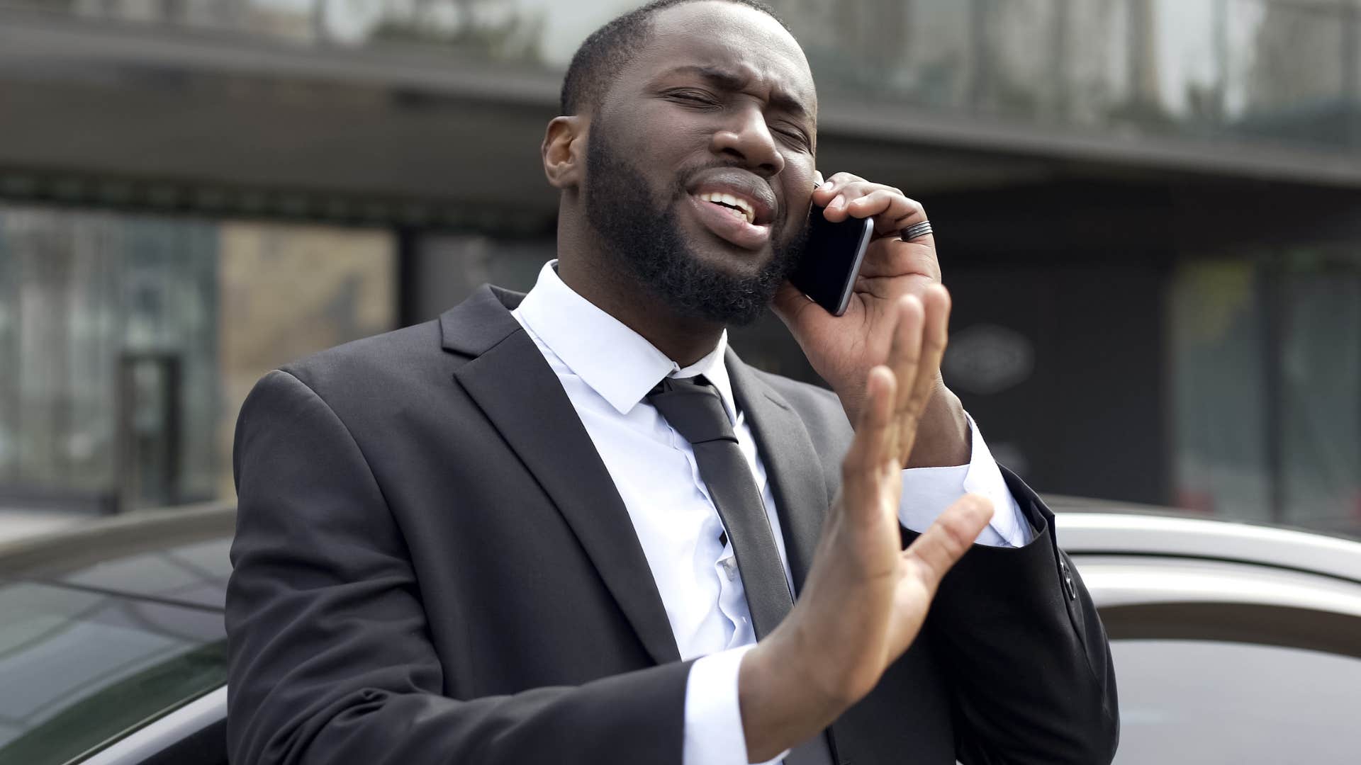 man avoiding people who flaunt their money talking on phone